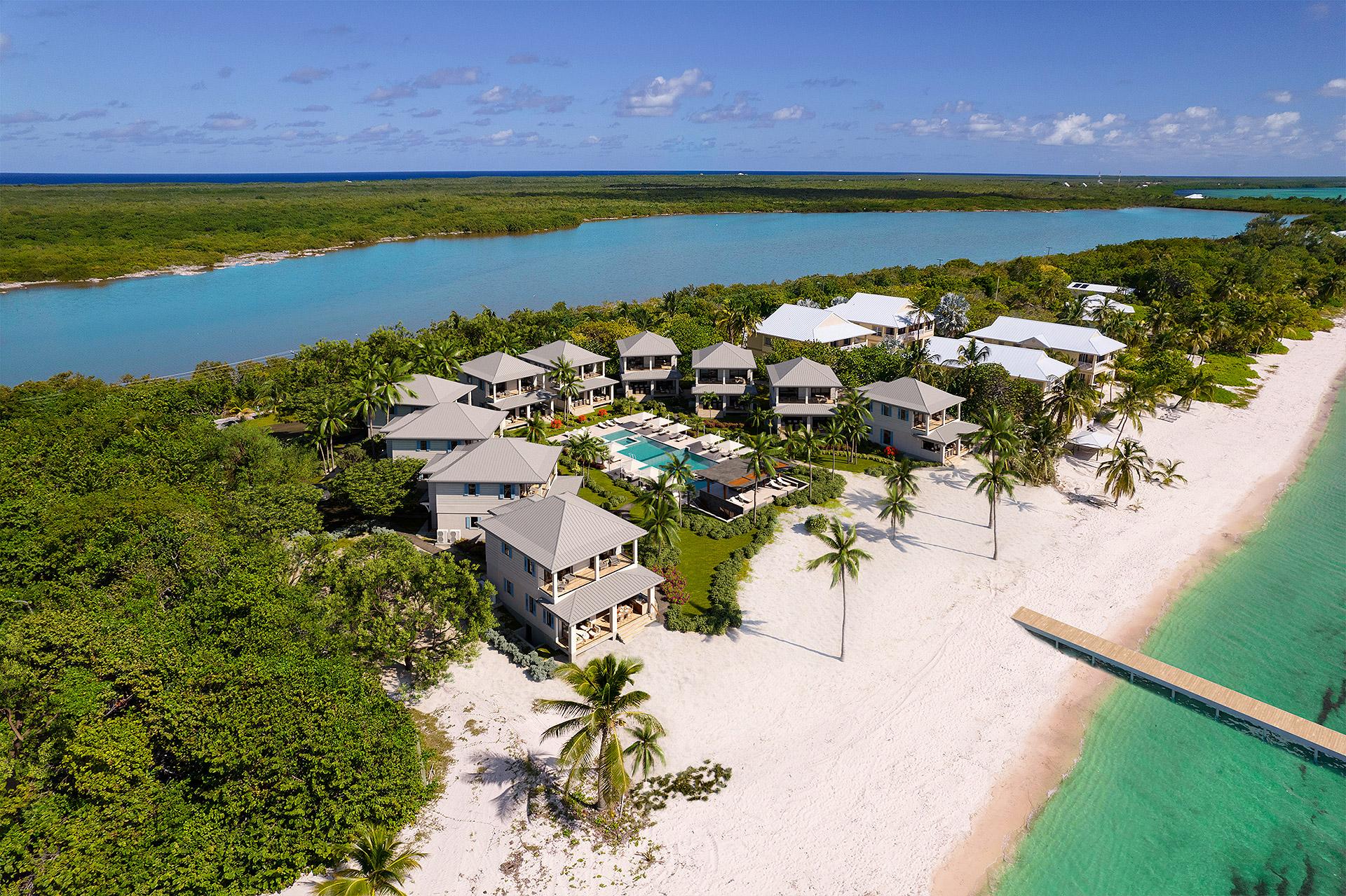 Aerial view of the MAREA villa compound on Little Cayman, set between beach and lagoon.